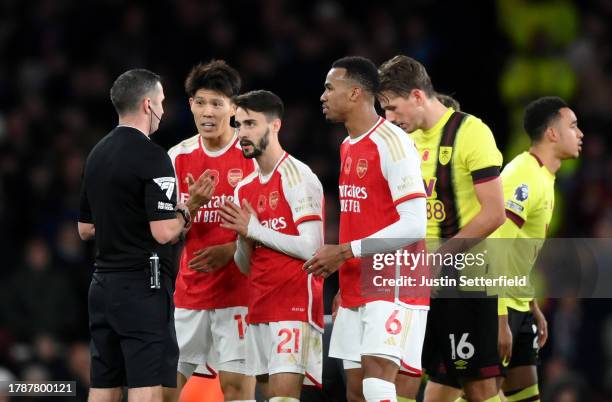 Referee Michael Oliver shows a red card to Fabio Vieira of Arsenal after foul on Josh Brownhill of Burnley during the Premier League match between...