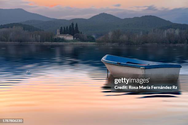 rowboat and reflection in lake of bayonles at sunset.  (estany de banyoles) - banyoles stock-fotos und bilder