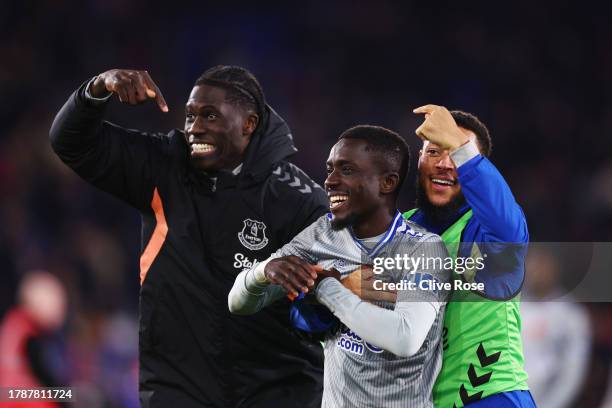 Idrissa Gueye of Everton celebrates at full time with teammates Amadou Onana and Arnaut Danjuma after the Premier League match between Crystal Palace...