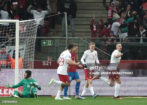 Poland's midfielder Jakub Piotrowski celebrates scoring the opening goal with his teammates during the UEFA Euro 2024 Group E qualification football...