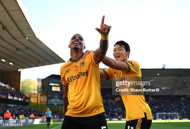 Mario Lemina of Wolverhampton Wanderers celebrates with teammate Hwang Hee-Chan after scoring the team's second goal during the Premier League match...