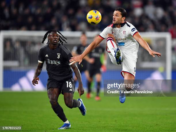 Alberto Dossena of Cagliari Calcio collects the ball ahead of Moise Kean of Juventus during the Serie A TIM match between Juventus and Cagliari...