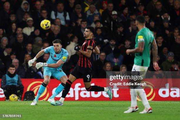 Nick Pope of Newcastle United clears the ball whilst under pressure from Dominic Solanke of AFC Bournemouth during the Premier League match between...