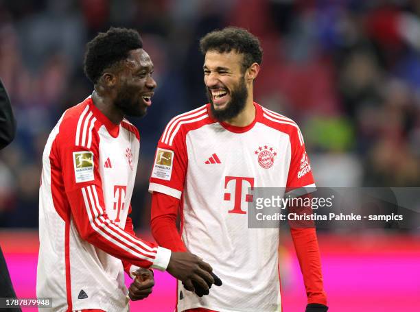 Alphonso Davies of FC Bayern Muenchen , Noussair Mazraoui of FC Bayern Muenchen celebrate victory after the Bundesliga match between FC Bayern...