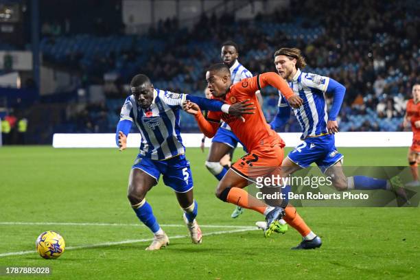 Bambo Diaby of Sheffield Wednesday challenges Aidomo Emakhu of Millwall for the ball during the Sky Bet Championship match between Sheffield...