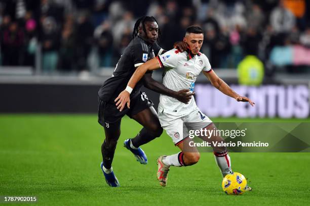 Gabriele Zappa of Cagliari Calcio and Moise Kean of Juventus battle for the ball during the Serie A TIM match between Juventus and Cagliari Calcio at...