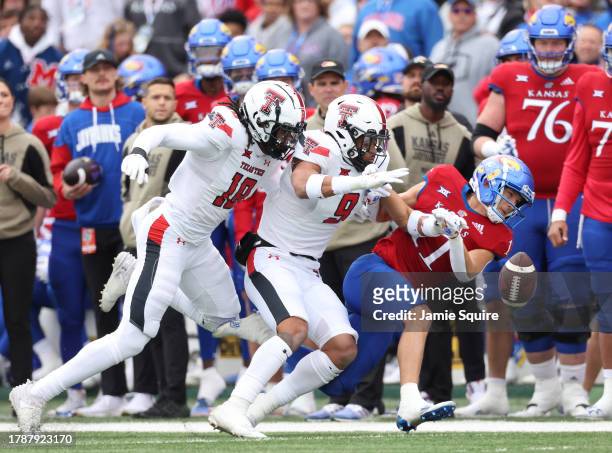 Defensive back Tyler Owens and defensive back C.J. Baskerville of the Texas Tech Red Raiders break up a pass intended for wide receiver Luke Grimm of...