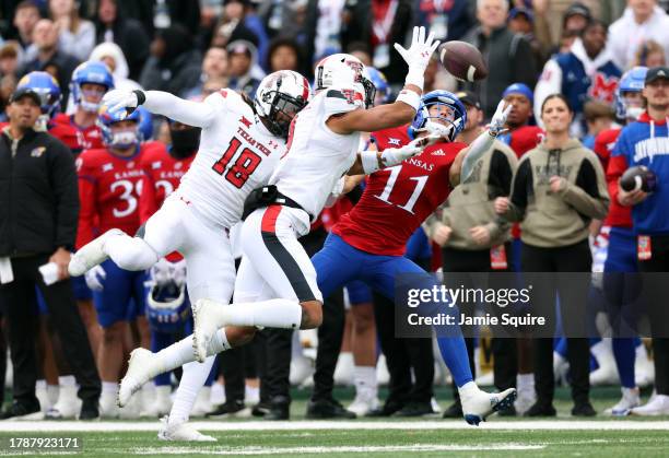 Defensive back Tyler Owens and defensive back C.J. Baskerville of the Texas Tech Red Raiders break up a pass intended for wide receiver Luke Grimm of...