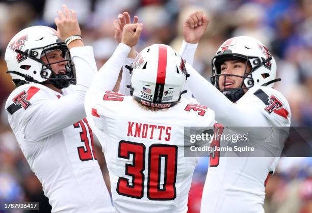 Kicker Gino Garcia of the Texas Tech Red Raiders celebrates after a kick with long snapper Jackson Knotts and punter Austin McNamara during the game...