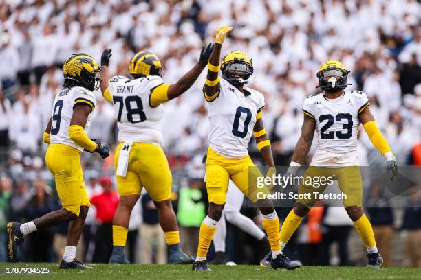 Rod Moore, Kenneth Grant, Mike Sainristil, and Michael Barrett of the Michigan Wolverines react to a play against the Penn State Nittany Lions during...