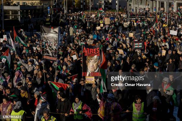 Demonstrators march in the city centre of the European capital holding banners against Israeli Prime Minister Benjamin Netanyahu during the European...