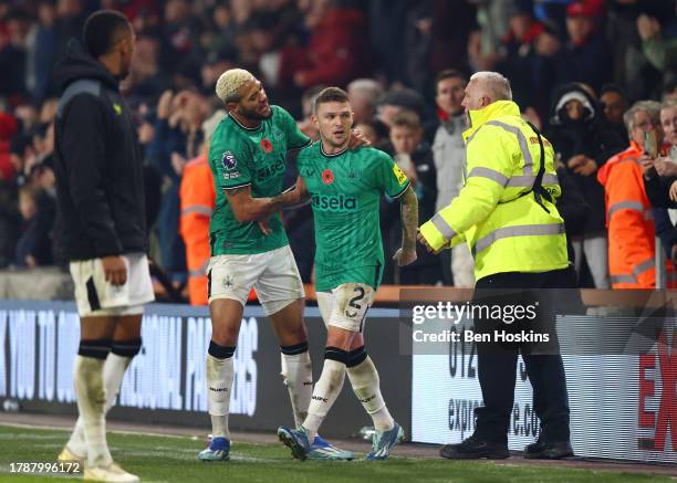 Kieran Trippier of Newcastle United is pulled away by teammate Joelinton after speaking to supporters during the Premier League match between AFC...