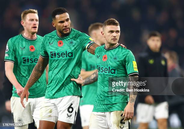 Kieran Trippier of Newcastle United is pulled away by teammate Jamaal Lascelles after speaking to supporters after the Premier League match between...