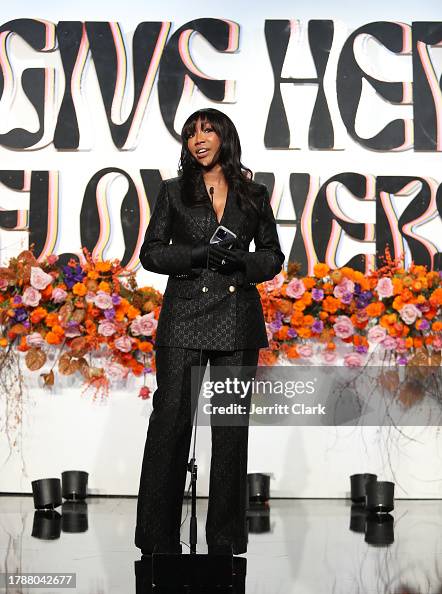 Brandy receives an award at the Femme It Forward Give Her FlowHERS ...