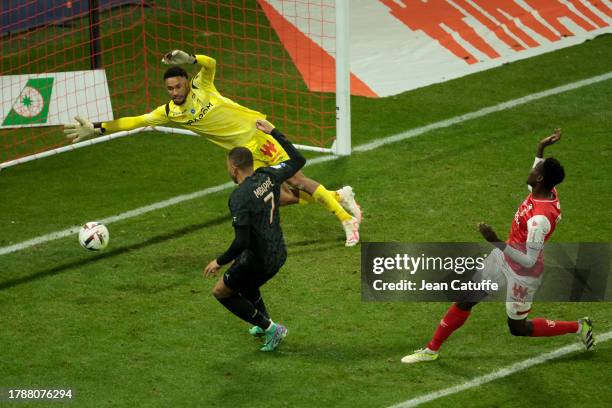 Kylian Mbappe of PSG scores his third goal against Reims goalkeeper Yehvann Diouf during the Ligue 1 Uber Eats match between Stade de Reims and Paris...