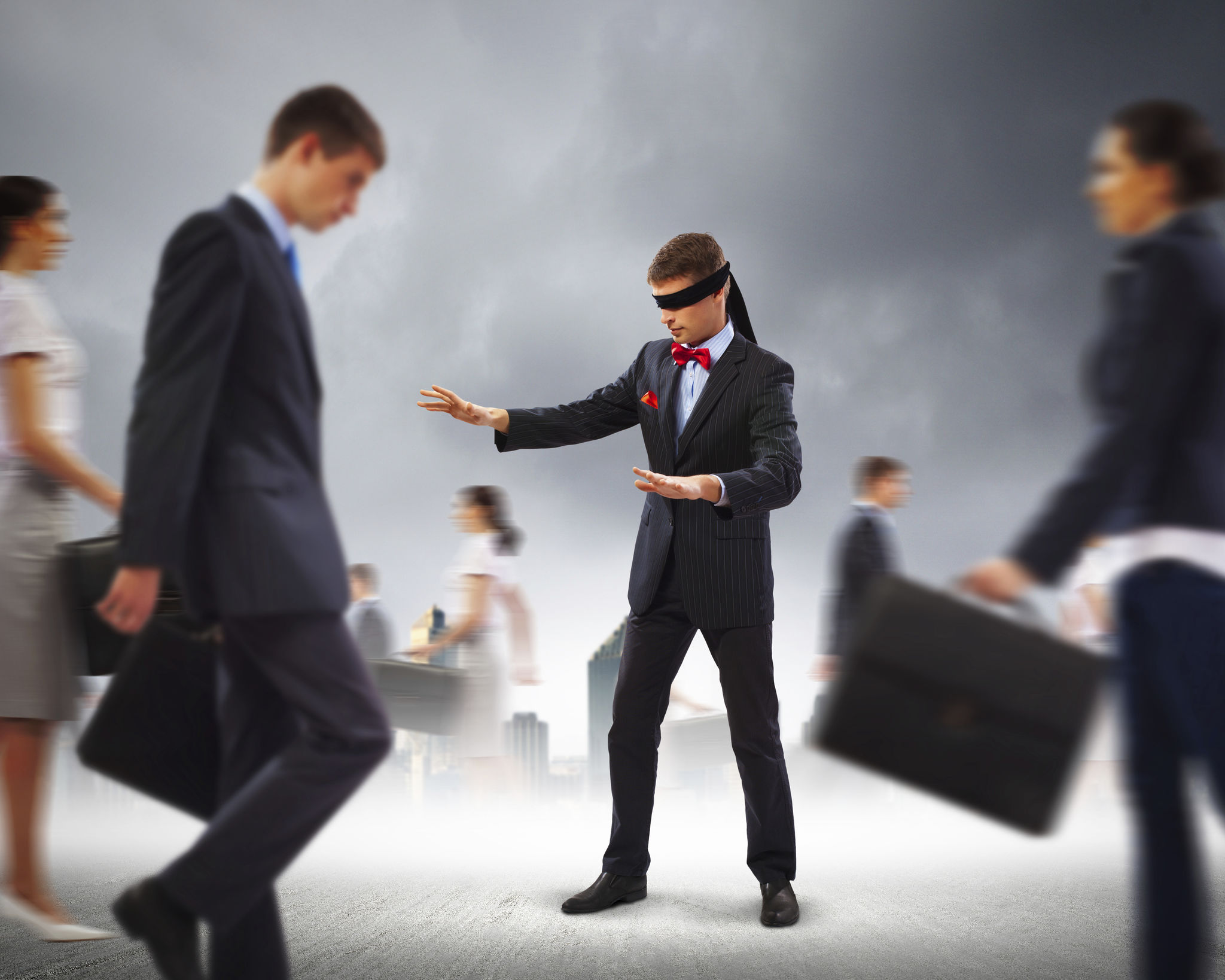 Businessman in blindfold among group of people Businessman in blindfold among group of people