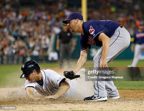Andy Dirks of the Detroit Tigers scores on wild pitch by Rick Hill of the Cleveland Indians during the seventh inning at Comerica Park on August 30,...