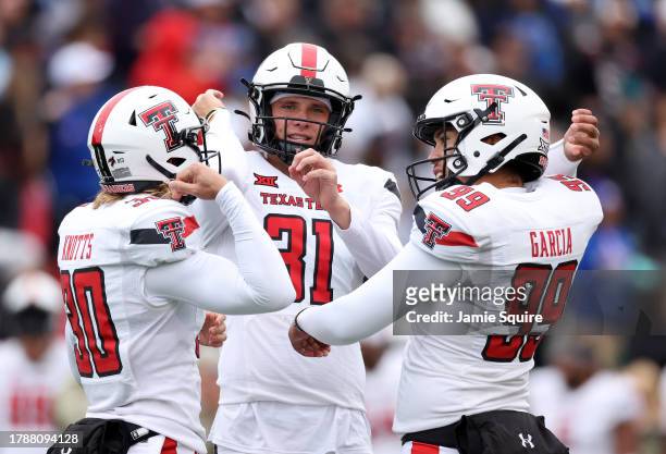 Kicker Gino Garcia of the Texas Tech Red Raiders celebrates after a kick with long snapper Jackson Knotts and punter Austin McNamara during the game...