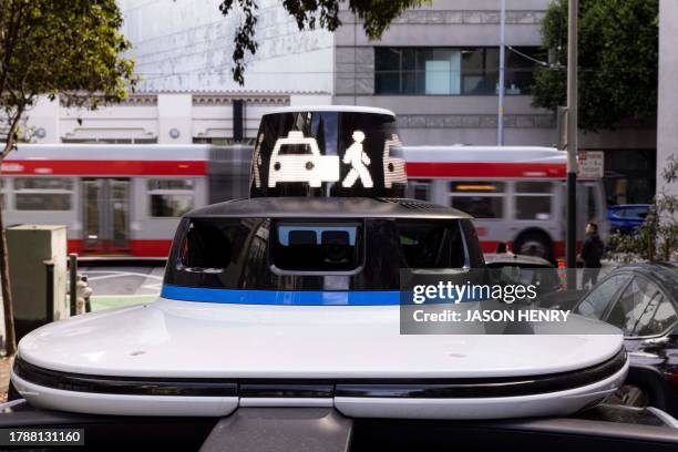 Waymo autonomous vehicle signals a drop-off on Brady Street in San Francisco, on November 17, 2023.