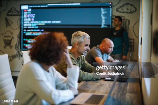 senior developers in a coworking space - hackathon stock pictures, royalty-free photos & images