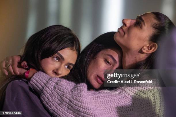 Survivors of the Nova Festival react while participating in a memorial and remembrance event at Kochav HaYam on November 11, 2023 in Caesarea,...