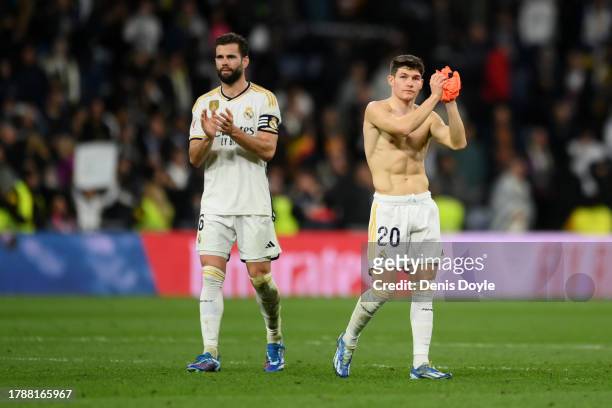 Nacho Fernandez and Fran Garcia of Real Madrid acknowledge the fans after the team's victory during the LaLiga EA Sports match between Real Madrid CF...