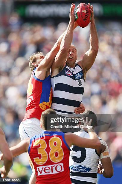 James Podsiadly of the Cats marks the ball against Joel Patfull of the Lions during the round 23 AFL match between the Geelong Cats and the Brisbane...