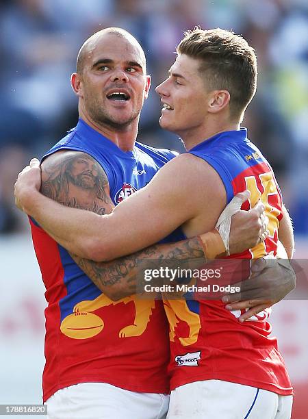 Ashley McGrath and Dayne Zorko of the Lions celebrate a goal during the round 23 AFL match between the Geelong Cats and the Brisbane Lions at Simonds...