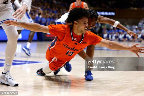 Josh Bascoe of the Bucknell Bison dives for a loose ball against Jeremy Roach of the Duke Blue Devils during the first half of the game at Cameron...