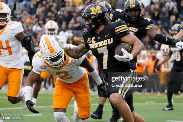 Running back Cody Schrader of the Missouri Tigers rushes past defensive back Jaylen McCollough of the Tennessee Volunteers in the first half at...