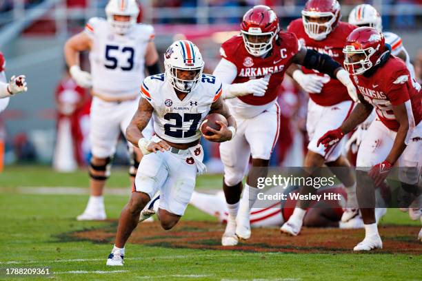 Jarquez Hunter of the Auburn Tigers runs the ball in the first half during the game against the Arkansas Razorback at Donald W. Reynolds Razorback...