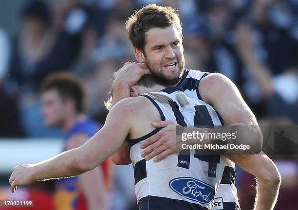 Joel Selwood is hugged by Jared Rivers of the Cats after kicking the winning goal during the round 23 AFL match between the Geelong Cats and the...