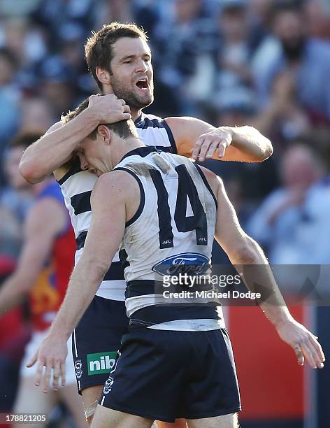 Joel Selwood is hugged by Jared Rivers of the Cats after kicking the winning goal during the round 23 AFL match between the Geelong Cats and the...
