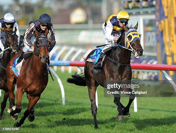 Brad Rawiller riding Ibicenco defeats Mark Zahra riding Mr O'ceirin in the Slickpix Stakes during Melbourne racing at Caulfield Racecourse on August...