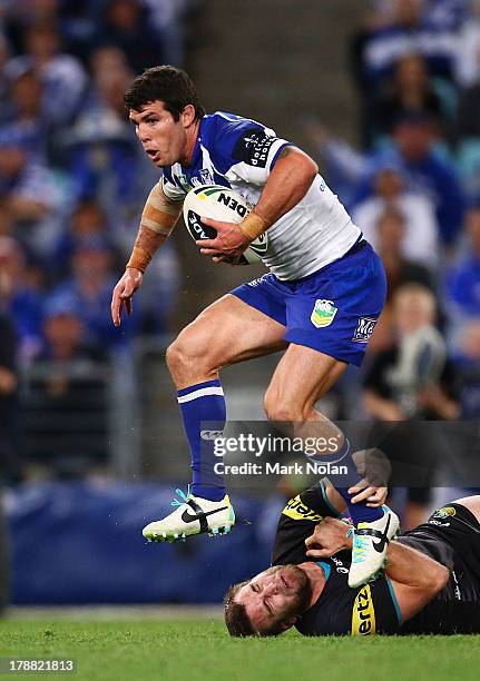 Michael Ennis of the Bulldogs jumps out of a tackle during the round 25 NRL match between the Canterbury Bulldogs and the Penrith Panthers at ANZ...