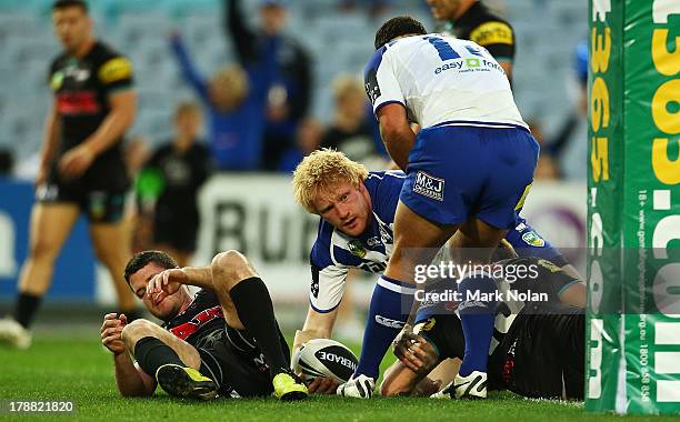 James Graham of the Bulldogs scores during the round 25 NRL match between the Canterbury Bulldogs and the Penrith Panthers at ANZ Stadium on August...