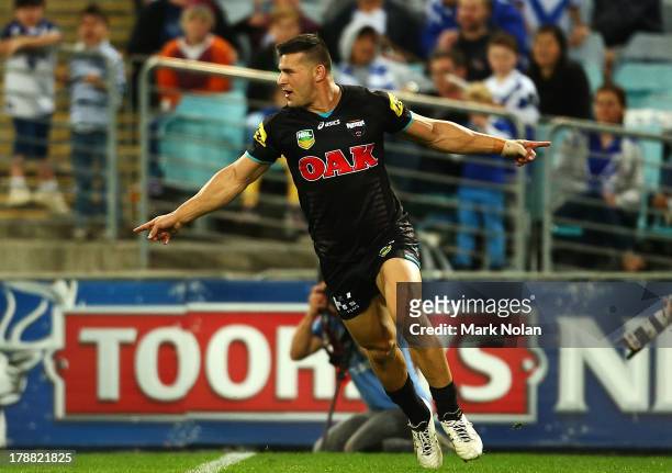 Josh Mansour of the Panthers celebrates scoring during the round 25 NRL match between the Canterbury Bulldogs and the Penrith Panthers at ANZ Stadium...