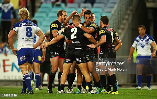 Josh Mansour of the Panthers is congratulated after scoring during the round 25 NRL match between the Canterbury Bulldogs and the Penrith Panthers at...