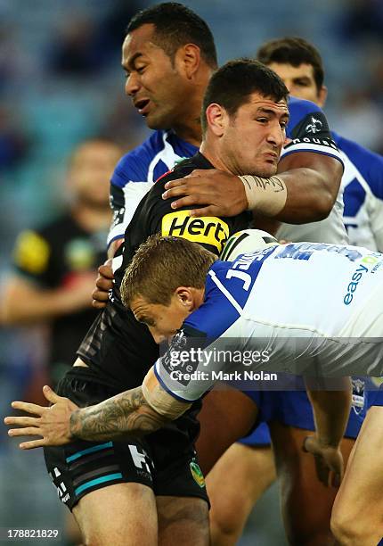 Sam McKendry of the Panthers is tackled during the round 25 NRL match between the Canterbury Bulldogs and the Penrith Panthers at ANZ Stadium on...