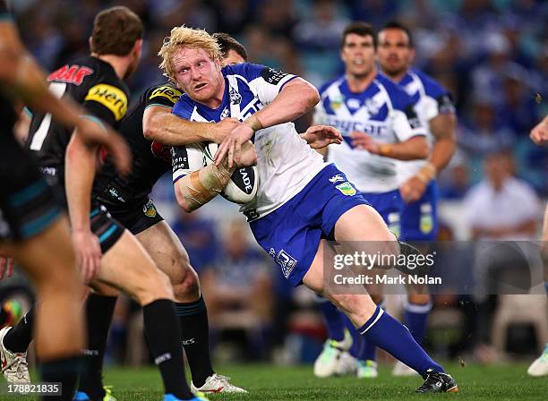 James Graham of the Bulldogs is tackled during the round 25 NRL match between the Canterbury Bulldogs and the Penrith Panthers at ANZ Stadium on...