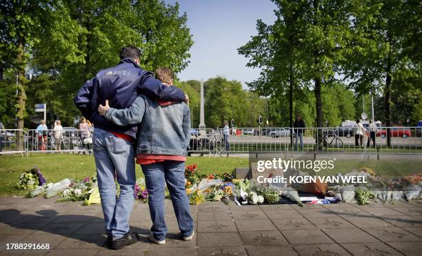 People gather at the war monument in Apeldoorn on May 1, 2009 where a man tried to ram his car into the Dutch royal family, killing five onlookers at...