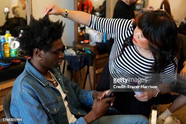 Hairstylist preparing model backstage during the Ashton Michael RTW + 10 Year Anniversary Show: 'Punk Tsugi' on November 11, 2023 in Los Angeles,...