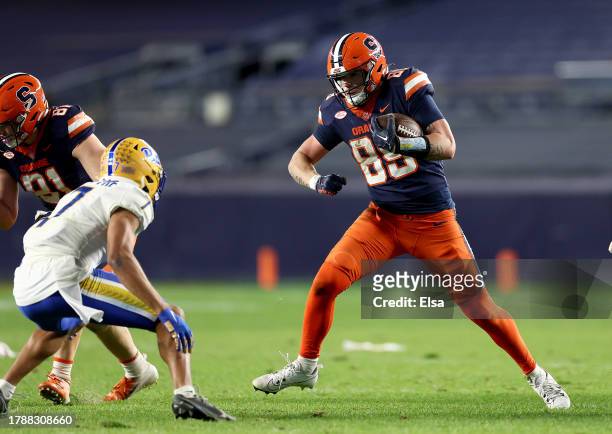 Dan Villari of the Syracuse Orange carries the ball as Javon McIntyre of the Pittsburgh Panthers defends during the second half at Yankee Stadium on...