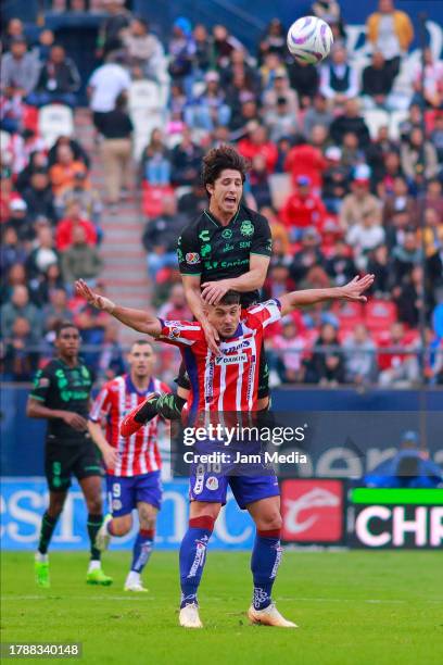 Javier Guemez of San Luis fights for the ball with Alan Cervantes of Santos during the 17th round match between Atletico San Luis and Santos Laguna...