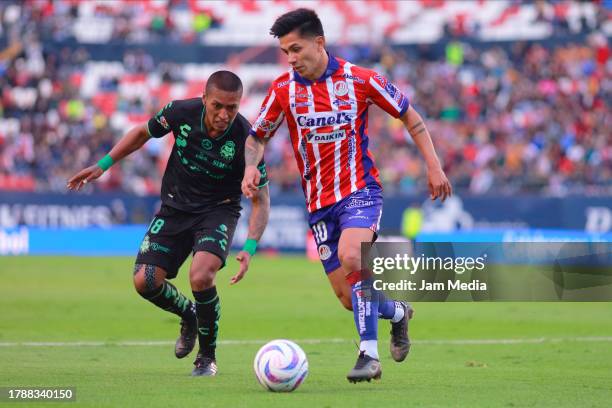 Pedro Aquino of Santos fights for the ball with Dieter Villalpando of San Luis during the 17th round match between Atletico San Luis and Santos...