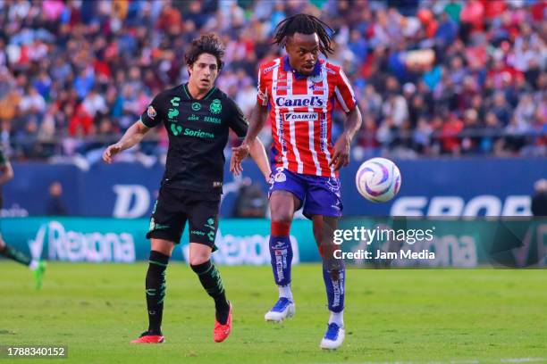 Alan Cervantes of Santos fights for the ball with Jhon Murillo of San Luis during the 17th round match between Atletico San Luis and Santos Laguna as...