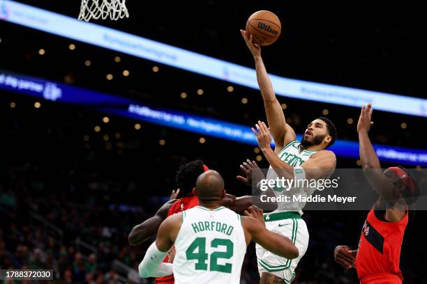 Jayson Tatum of the Boston Celtics takes a shot past Precious Achiuwa of the Toronto Raptors during the first quarter at TD Garden on November 11,...