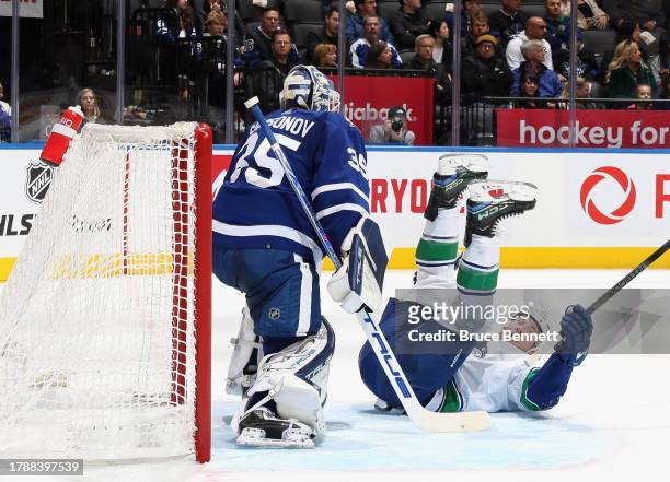 Brock Boeser of the Vancouver Canucks hits the ice in front of Ilya Samsonov of the Toronto Maple Leafs during the first period at Scotiabank Arena...