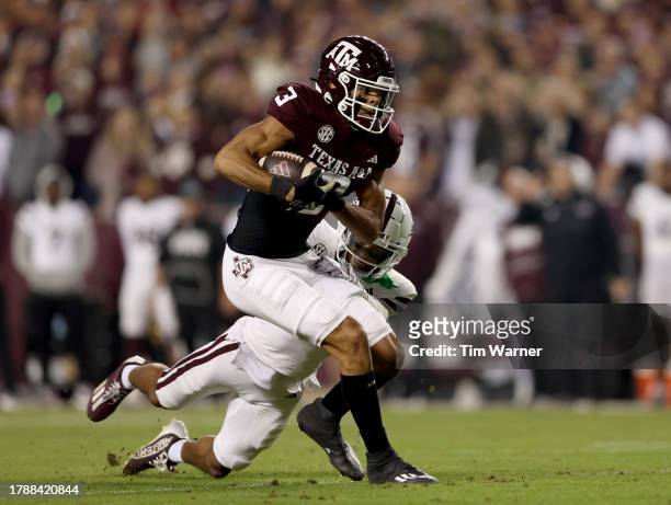 Noah Thomas of the Texas A&M Aggies runs after a reception while defended by Marcus Banks of the Mississippi State Bulldogs in the first quarter at...