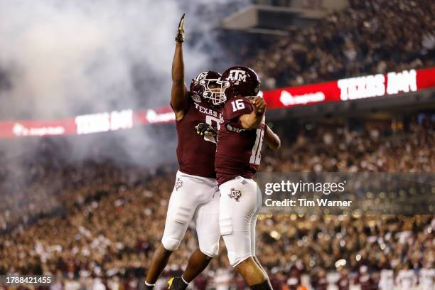 Ainias Smith of the Texas A&M Aggies congratulates Jaylen Henderson after a touchdown in the first quarter against the Mississippi State Bulldogs at...